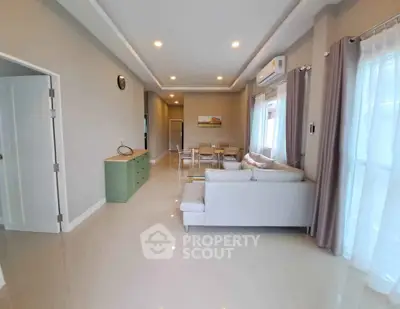 Spacious modern living room with elegant decor and ample natural light