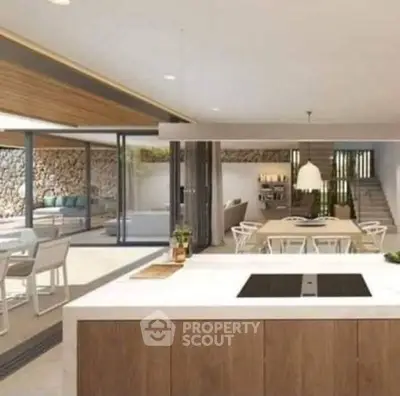 Luxurious open-plan kitchen with modern dining area and outdoor view.