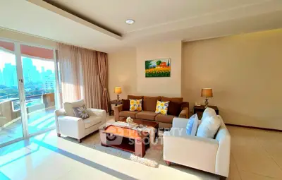 Spacious living room with modern decor and large windows offering city views.