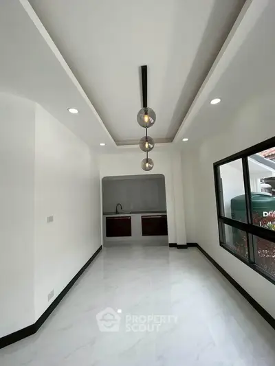 Modern minimalist interior with sleek lighting and large window, perfect for stylish living.