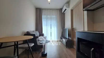 Modern living room with cozy sofa, TV, and dining area in stylish apartment.