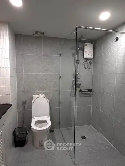 Modern bathroom with glass shower and sleek tile design