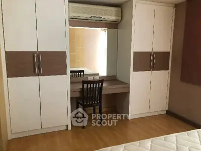 Spacious bedroom with built-in wardrobe and vanity desk