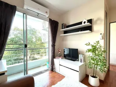 Charming living room with balcony access and modern decor