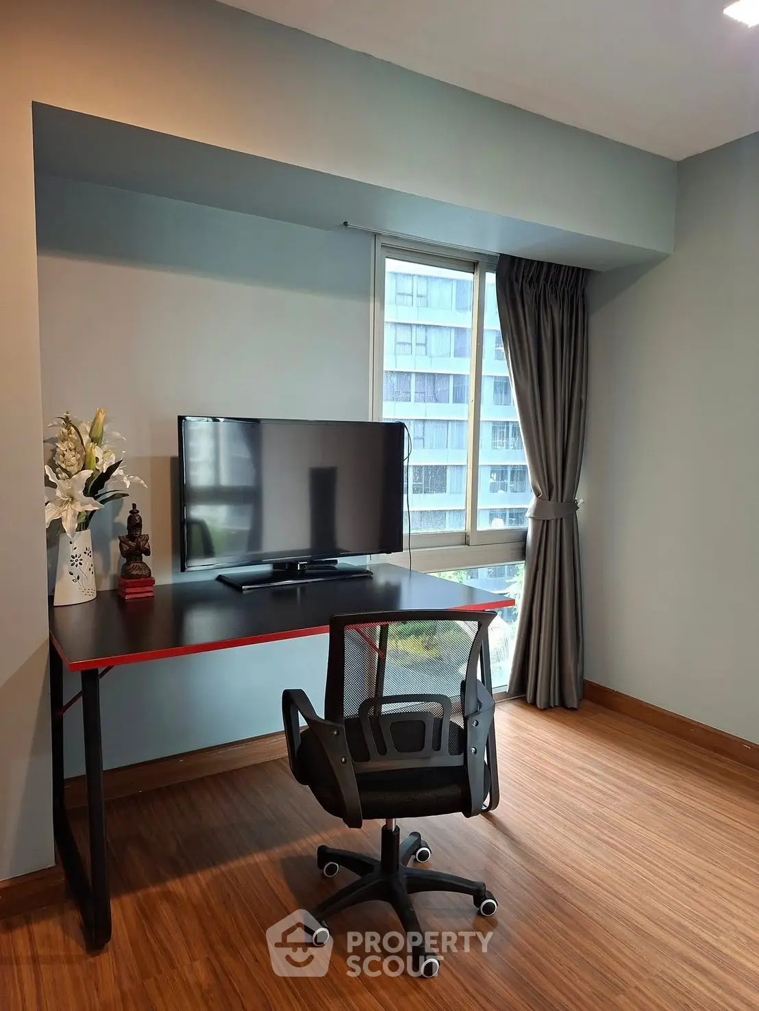 Modern study area with sleek desk and chair, featuring a large window view.