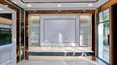 Luxurious modern living room with elegant marble feature wall and sleek glass shelving.