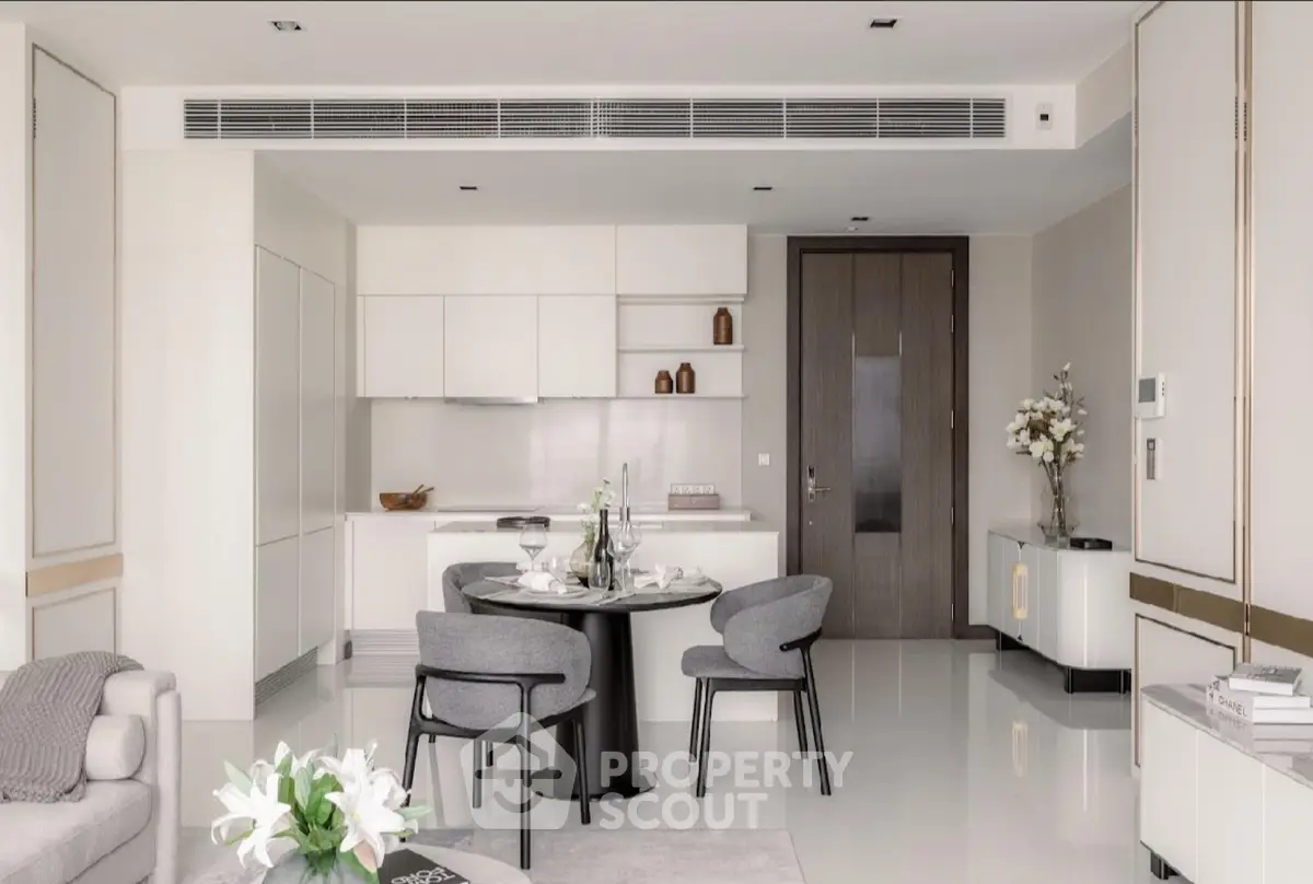 Modern open-plan living room with sleek kitchen and elegant dining area in luxury apartment.