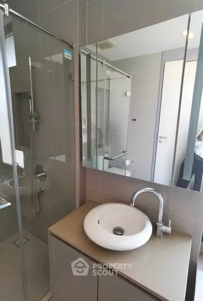 Modern bathroom with sleek fixtures and glass shower enclosure