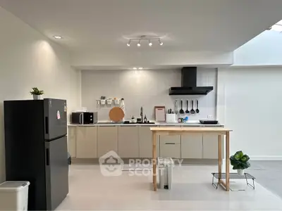 Modern kitchen with sleek cabinets and appliances, featuring an open layout and minimalist design.