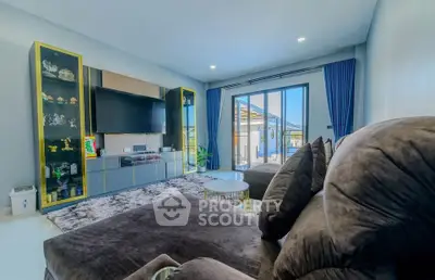 Spacious modern living room with plush seating and large windows for natural light.