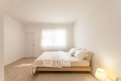 Minimalist bedroom with natural light and cozy decor
