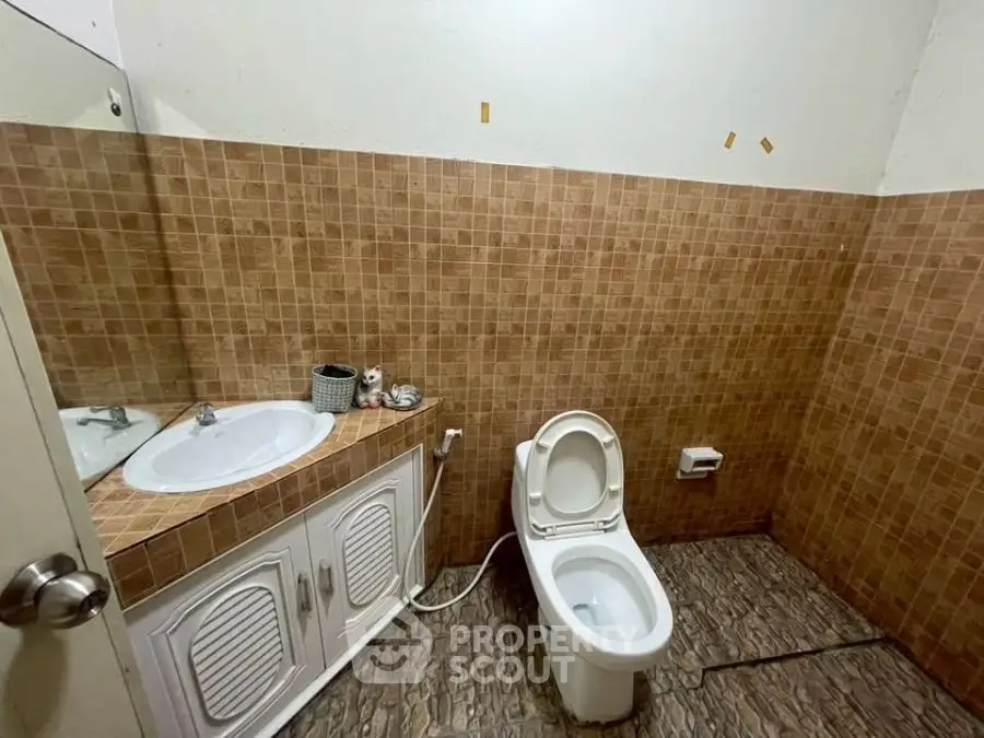 Spacious bathroom with tiled walls and modern fixtures