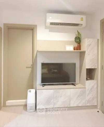 Modern living room with sleek TV unit and air conditioning, perfect for comfortable living.