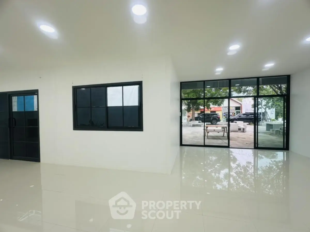 Spacious modern interior with large windows and glossy floors, perfect for versatile use.