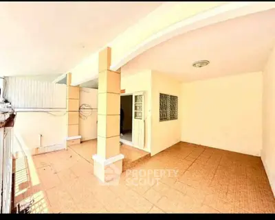 Spacious covered balcony with tiled flooring and modern design, perfect for outdoor relaxation.