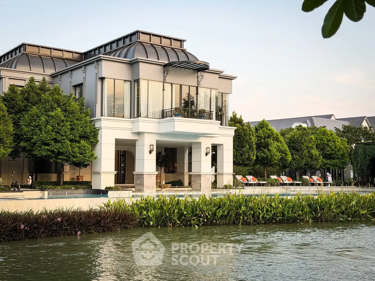 Luxurious riverside villa with modern architecture and lush greenery