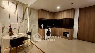 Modern kitchen with washing machine and dining area in stylish apartment