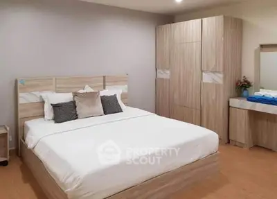 Spacious bedroom with modern wooden furniture and cozy bedding