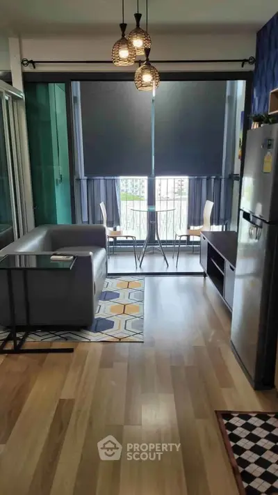 Modern living room with balcony view, stylish decor, and natural light
