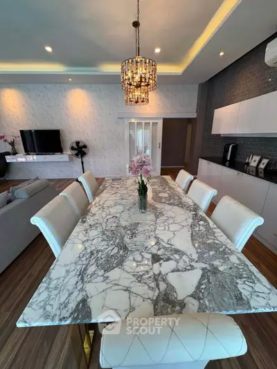Luxurious dining area with elegant marble table and modern decor in a stylish living room setting.