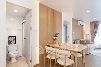 Modern open-plan living and dining area with wooden accents and cozy decor.