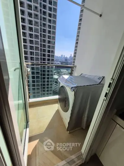 High-rise balcony with city view and washing machine, perfect urban living space.