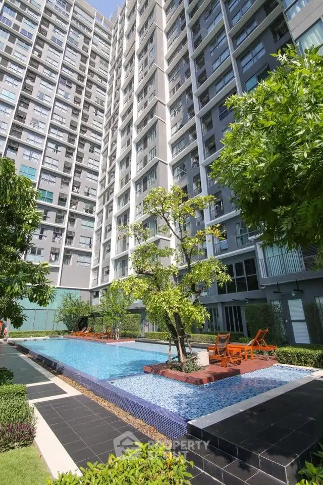 Modern condominium with pool and lush garden, perfect for urban living.