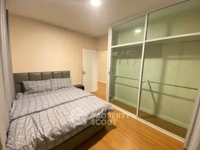 Modern bedroom with stylish bed and spacious walk-in closet