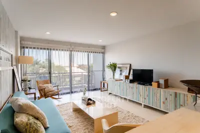 Stylish living room with modern decor and large windows offering natural light.