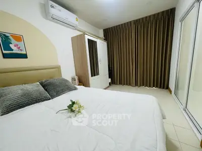 Cozy bedroom with modern decor, featuring a comfortable bed, wardrobe, and air conditioning.