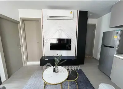 Modern living room with air conditioning, TV, and stylish furniture in a contemporary apartment.