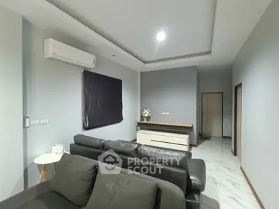 Modern living room with sleek furniture and air conditioning in a stylish apartment.