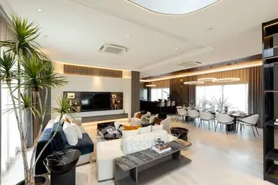 Luxurious open-plan living and dining area with modern decor and ample natural light.
