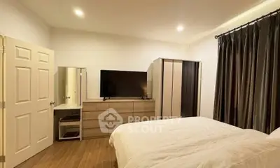 Spacious bedroom with modern furnishings and ample storage in a cozy apartment.