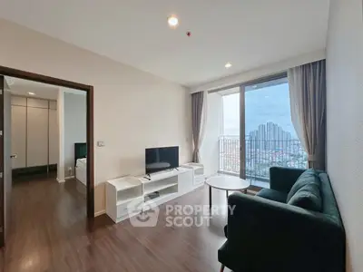 Modern living room with city view and balcony access in high-rise apartment