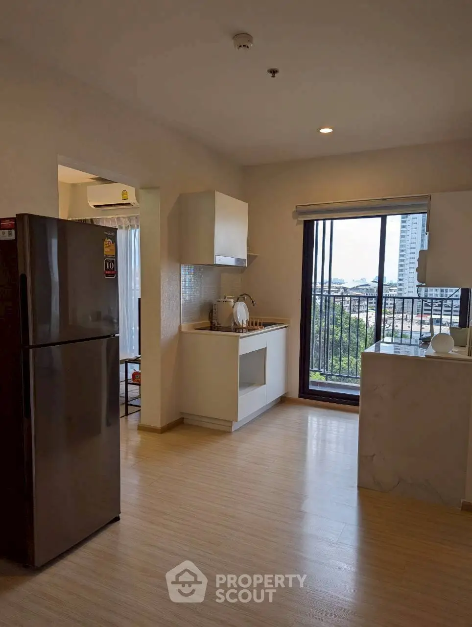 Modern kitchen with open layout and balcony view in urban apartment