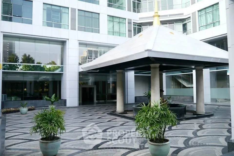 Modern building entrance with elegant canopy and stylish paving