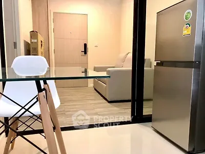 Modern apartment interior with sleek furniture and stainless steel fridge