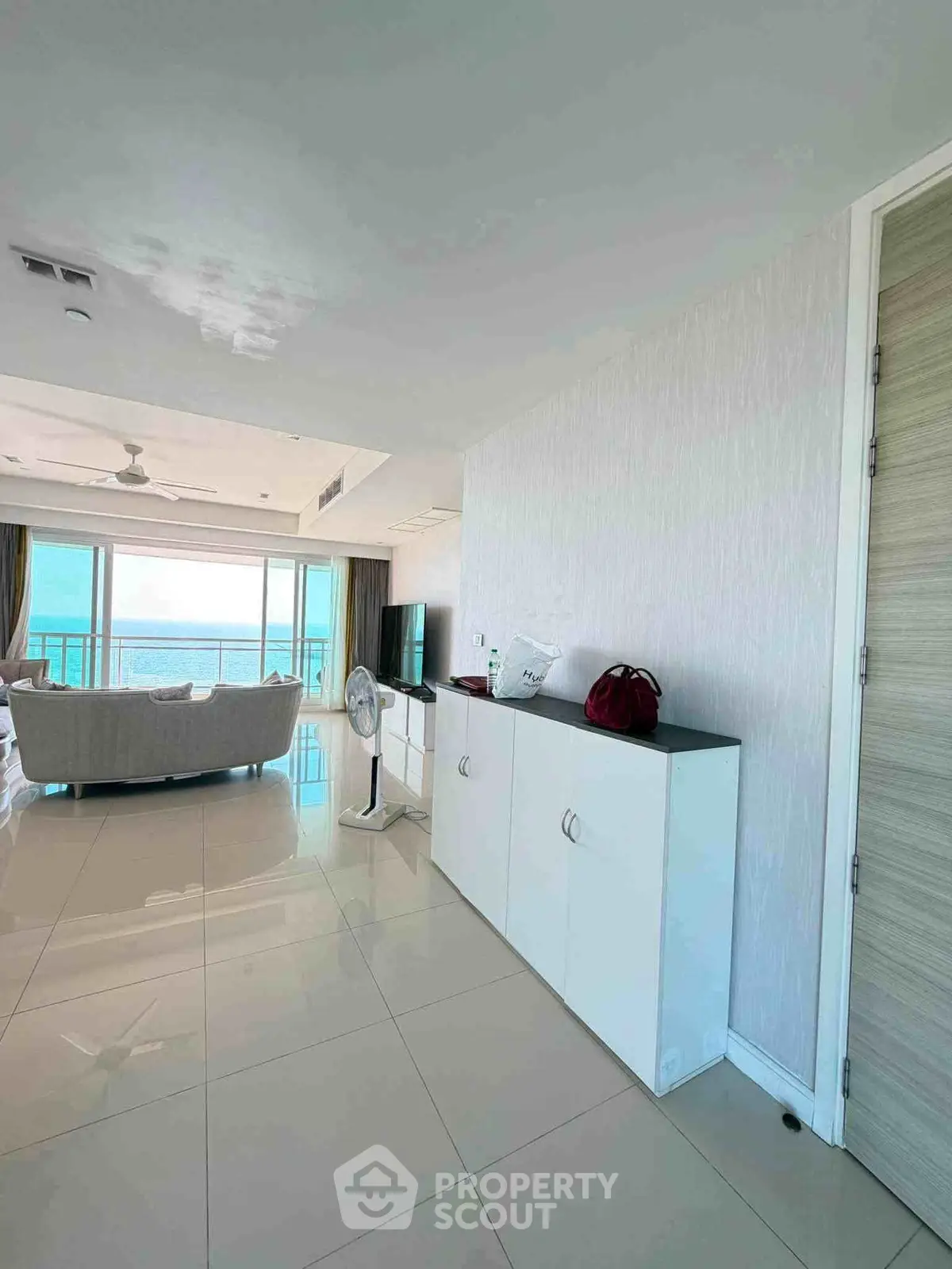 Spacious modern living room with ocean view and sleek white furniture