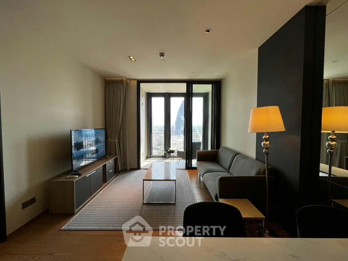 Modern living room with city view, sleek furniture, and large windows in a high-rise apartment.