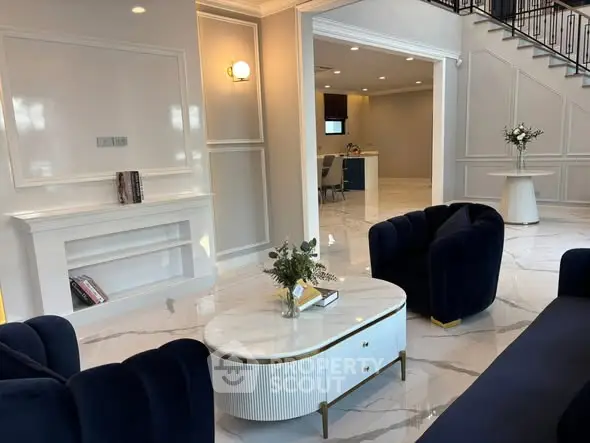 Luxurious living room with elegant navy sofas and marble flooring