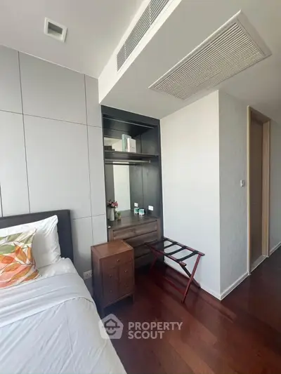 Modern bedroom with sleek design and wooden flooring