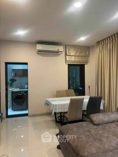 Modern living room with dining area and air conditioning