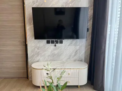 Modern living room with wall-mounted TV and stylish console table