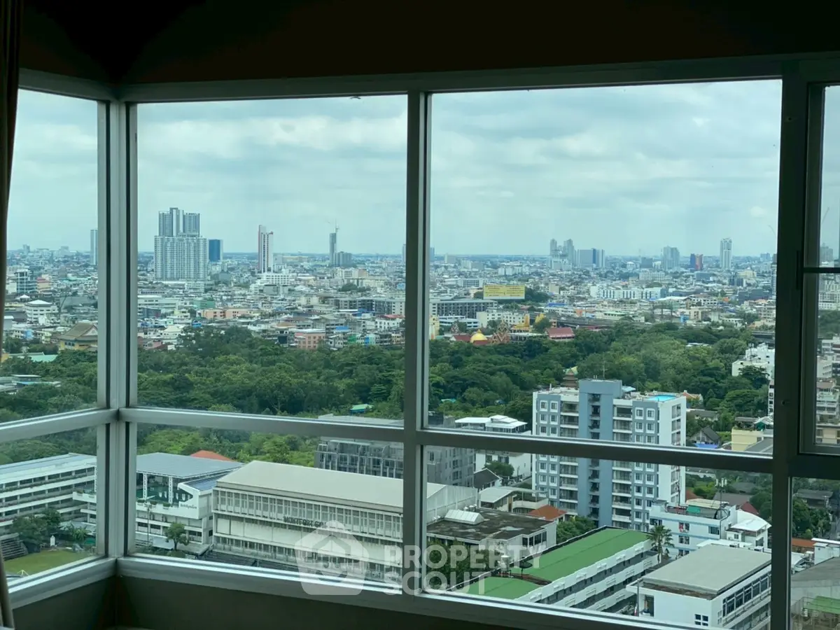 Stunning panoramic city view from high-rise apartment window.