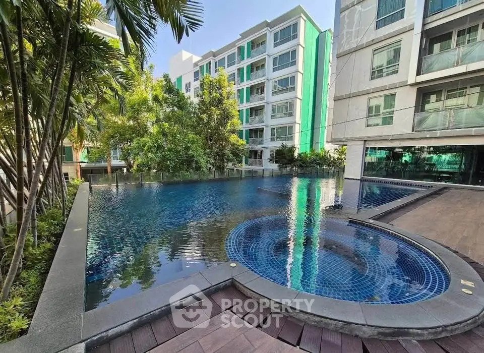Luxurious condo with stunning pool and lush greenery, perfect for relaxation and modern living.
