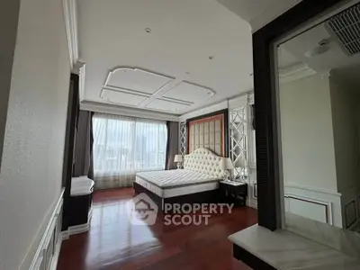 Luxurious bedroom with elegant decor and city view, featuring a plush bed and large windows.