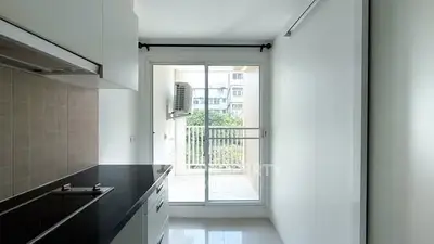 Modern kitchen with sleek design and balcony view, perfect for urban living.