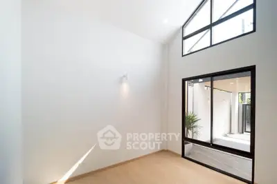 Spacious modern living room with high ceilings and large windows for natural light.