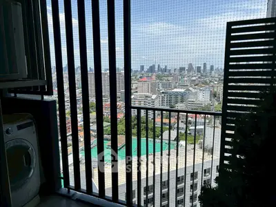 Stunning city view from high-rise balcony with washing machine